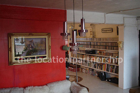 Warehouse conversion apartment with retro decor and concrete floors, in East London.