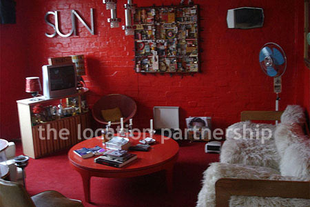 Warehouse conversion apartment with retro decor and concrete floors, in East London.