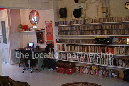 Warehouse conversion apartment with retro decor and concrete floors, in East London.