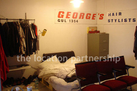Warehouse conversion apartment with retro decor and concrete floors, in East London.