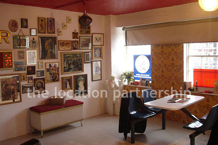 Warehouse conversion apartment with retro decor and concrete floors, in East London.