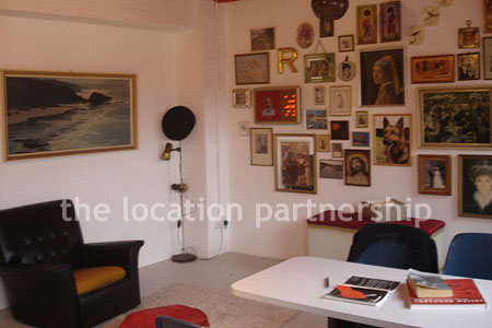 Warehouse conversion apartment with retro decor and concrete floors, in East London.