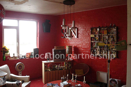 Warehouse conversion apartment with retro decor and concrete floors, in East London.
