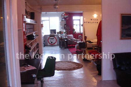 Warehouse conversion apartment with retro decor and concrete floors, in East London.