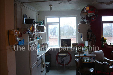 Warehouse conversion apartment with retro decor and concrete floors, in East London.