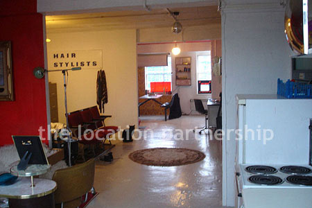 Warehouse conversion apartment with retro decor and concrete floors, in East London.