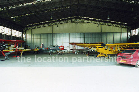 Aircraft Hanger with a number of small historic planes