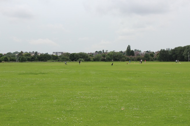 Athletics track surrounding various athletic setups with a playing field and tennis courts adjacent.