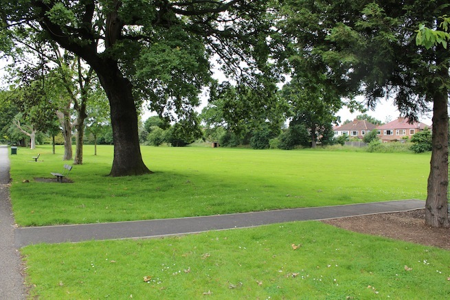 Athletics track surrounding various athletic setups with a playing field and tennis courts adjacent.