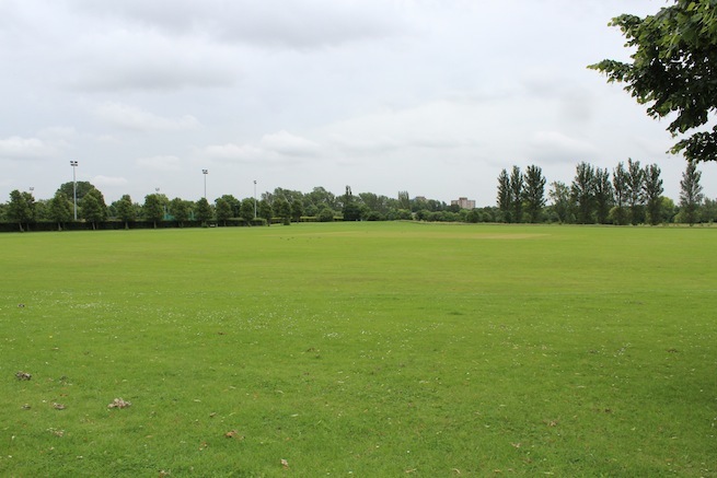 Athletics track surrounding various athletic setups with a playing field and tennis courts adjacent.