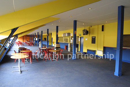Large blue and yellow canteen, restaurant area at event venue