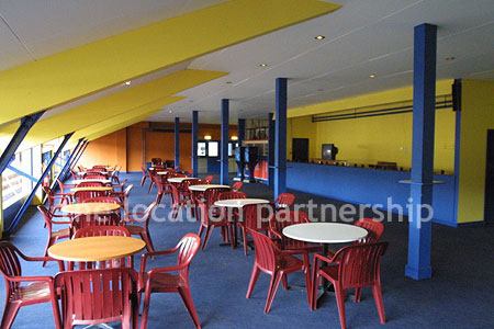 Large blue and yellow canteen, restaurant area at event venue