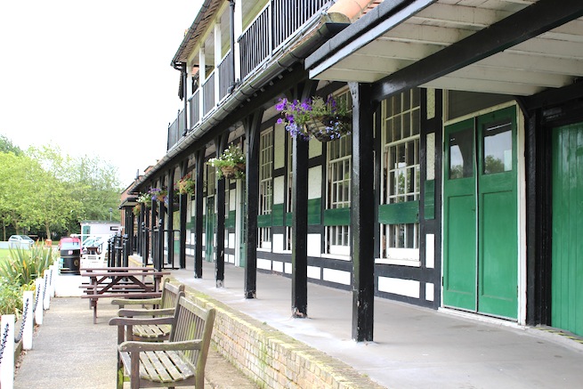 Lovely cricket pavilion built in 1886 filled with memorabilia inside. Listed building. Surrounded by cricket pitch and athletics track.