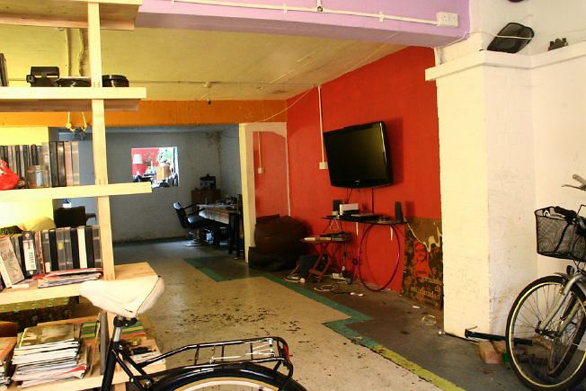 Workshop converted into a flat on one level with 4 bedrooms, concrete floors and exposed brick walls.