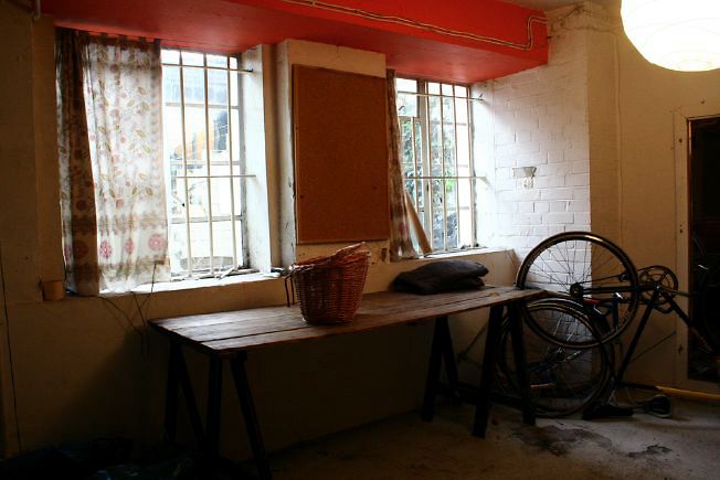 Workshop converted into a flat on one level with 4 bedrooms, concrete floors and exposed brick walls.