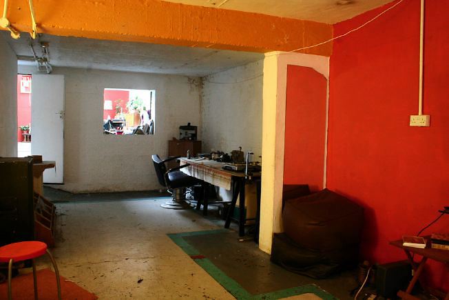 Workshop converted into a flat on one level with 4 bedrooms, concrete floors and exposed brick walls.