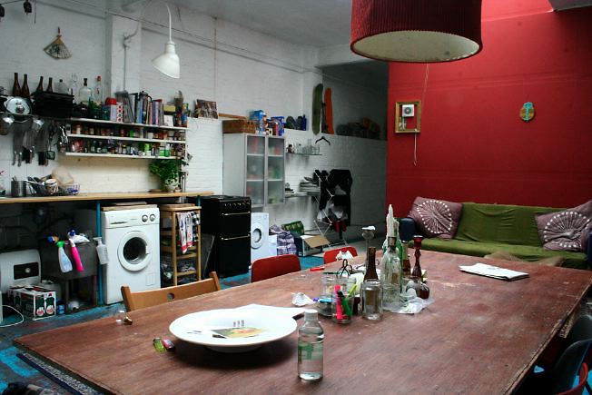 Workshop converted into a flat on one level with 4 bedrooms, concrete floors and exposed brick walls.