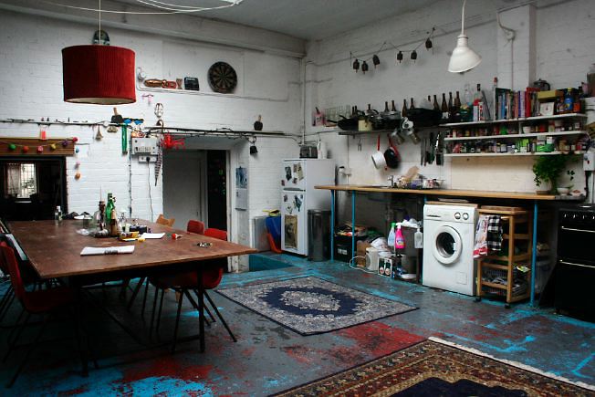 Workshop converted into a flat on one level with 4 bedrooms, concrete floors and exposed brick walls.