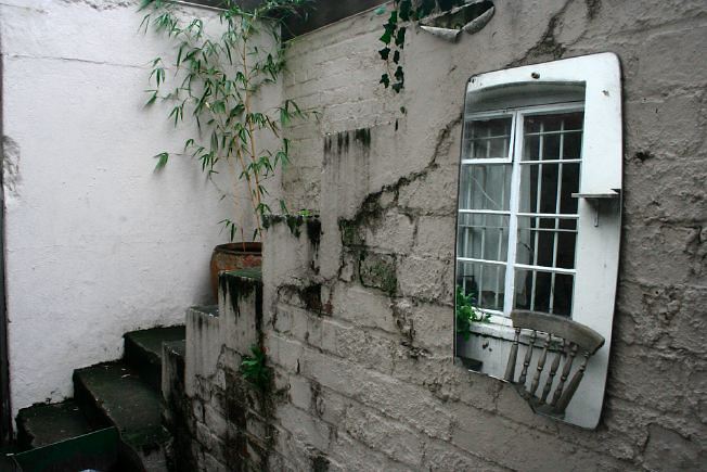 Workshop converted into a flat on one level with 4 bedrooms, concrete floors and exposed brick walls.