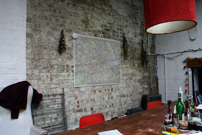 Workshop converted into a flat on one level with 4 bedrooms, concrete floors and exposed brick walls.