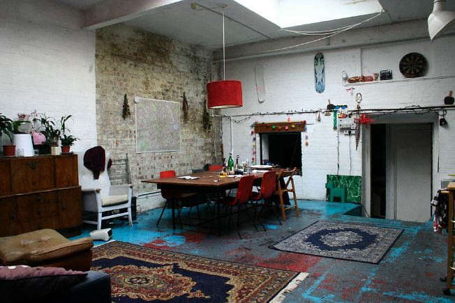 Workshop converted into a flat on one level with 4 bedrooms, concrete floors and exposed brick walls.