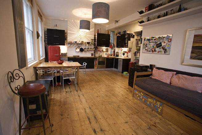 Bright, modern flat with wooden floors and open kitchen and living areas.