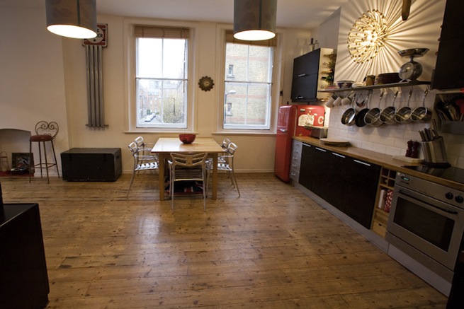 Bright, modern flat with wooden floors and open kitchen and living areas.