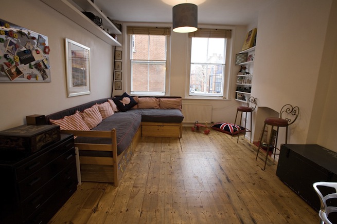 Bright, modern flat with wooden floors and open kitchen and living areas.
