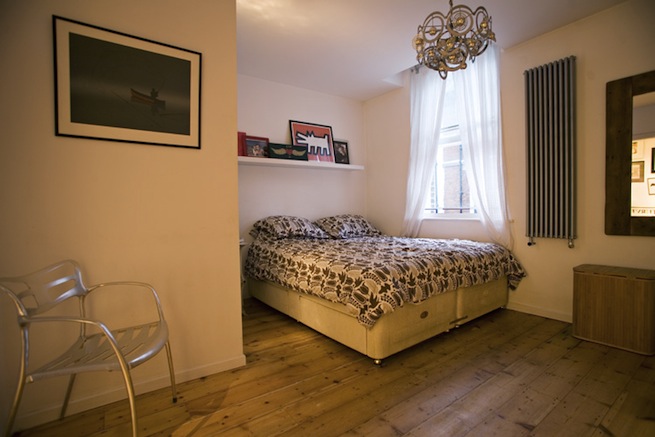 Bright, modern flat with wooden floors and open kitchen and living areas.
