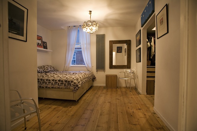 Bright, modern flat with wooden floors and open kitchen and living areas.