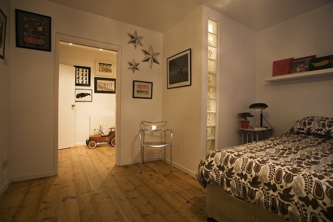 Bright, modern flat with wooden floors and open kitchen and living areas.
