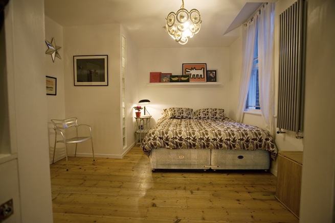Bright, modern flat with wooden floors and open kitchen and living areas.