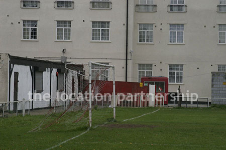 Classic traditional small football ground surrounded by houses.