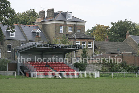Classic traditional small football ground surrounded by houses.