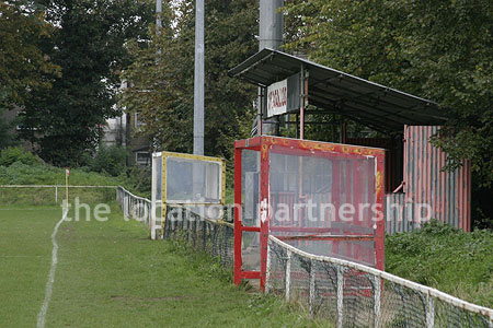 Classic traditional small football ground surrounded by houses.