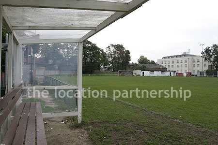 Classic traditional small football ground surrounded by houses.