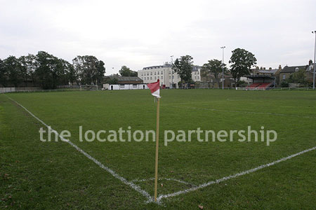 Classic traditional small football ground surrounded by houses.
