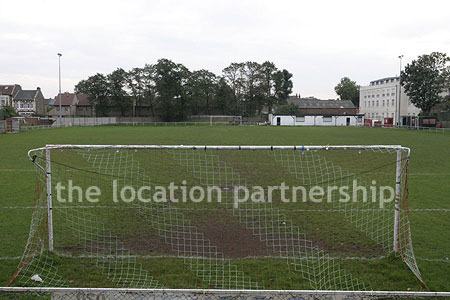 Classic traditional small football ground surrounded by houses.