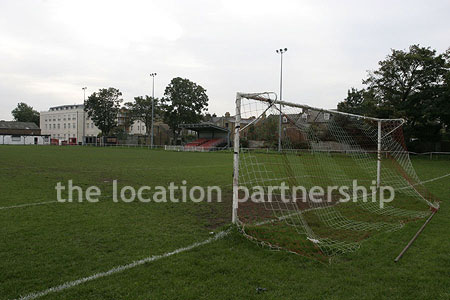 Classic traditional small football ground surrounded by houses.