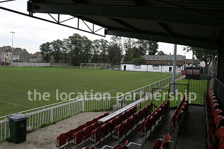 Classic traditional small football ground surrounded by houses.