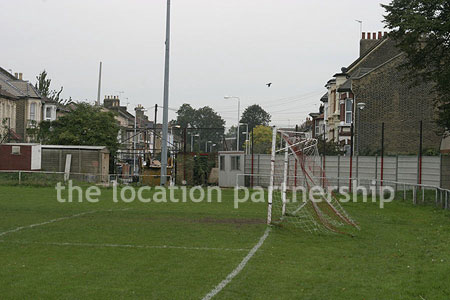 Classic traditional small football ground surrounded by houses.