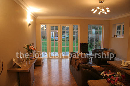 Contemporary feeling sitting room with wooden floor