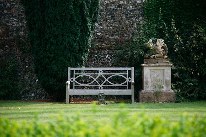 Characterful exterior and gardens of beautiful country house with treehouse, outbuildings, barns, swimming pool and tennis court.