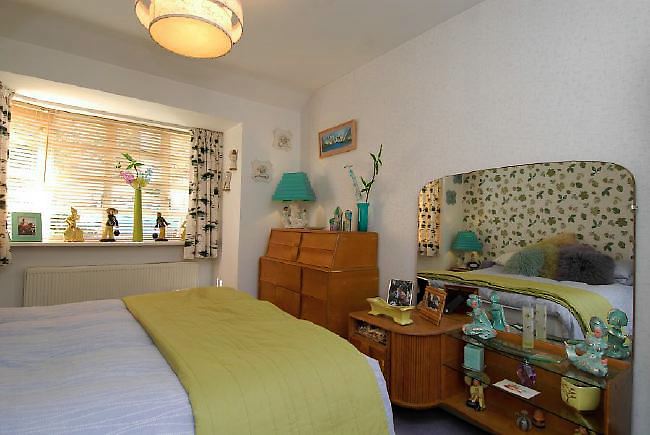Pre-war bungalow renovated to give a Californian mid century Modern feel. The furnishings, fittings and decor are all authentic 40's. 50's. There is a large front and rear garden and long private driveway.