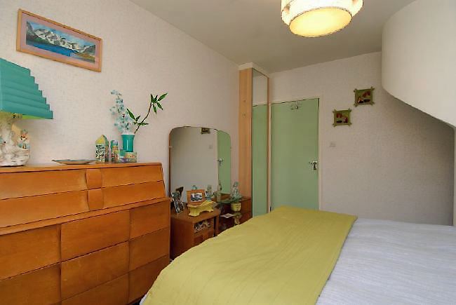 Pre-war bungalow renovated to give a Californian mid century Modern feel. The furnishings, fittings and decor are all authentic 40's. 50's. There is a large front and rear garden and long private driveway.