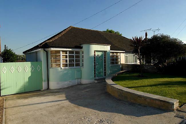 Pre-war bungalow renovated to give a Californian mid century Modern feel. The furnishings, fittings and decor are all authentic 40's. 50's. There is a large front and rear garden and long private driveway.
