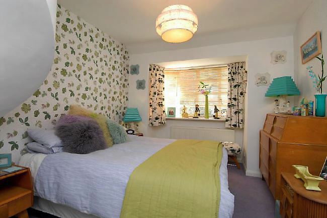 Pre-war bungalow renovated to give a Californian mid century Modern feel. The furnishings, fittings and decor are all authentic 40's. 50's. There is a large front and rear garden and long private driveway.
