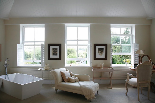 Great contemporary free-standing bath in a huge light bedroom with plantation shutters and a separate en-suite.