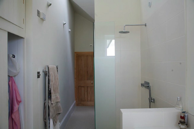 Great contemporary free-standing bath in a huge light bedroom with plantation shutters and a separate en-suite.