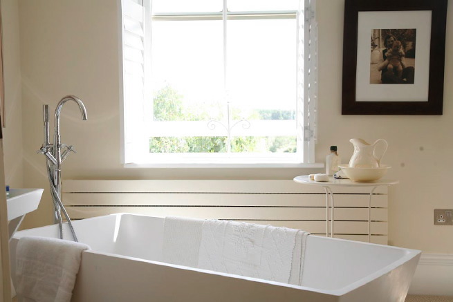 Great contemporary free-standing bath in a huge light bedroom with plantation shutters and a separate en-suite.